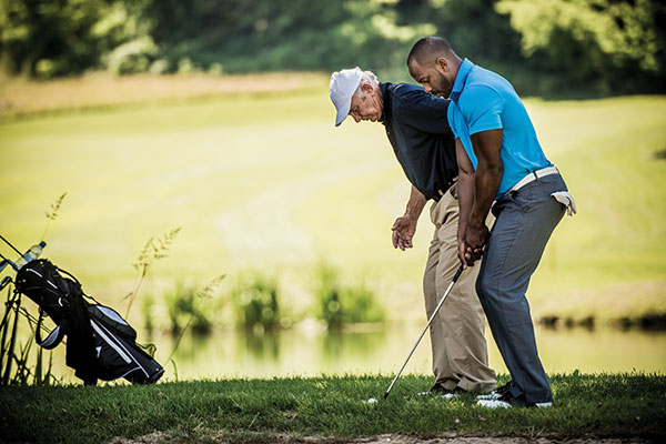 men golfing and getting lessons men golfing and getting lessons