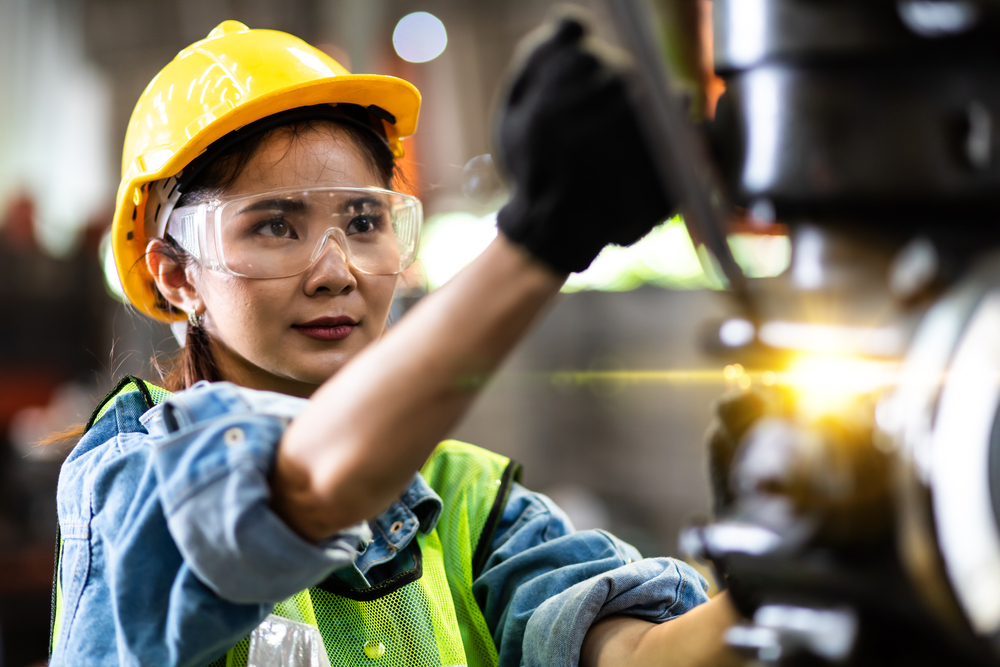 Female mechanic operating tools
