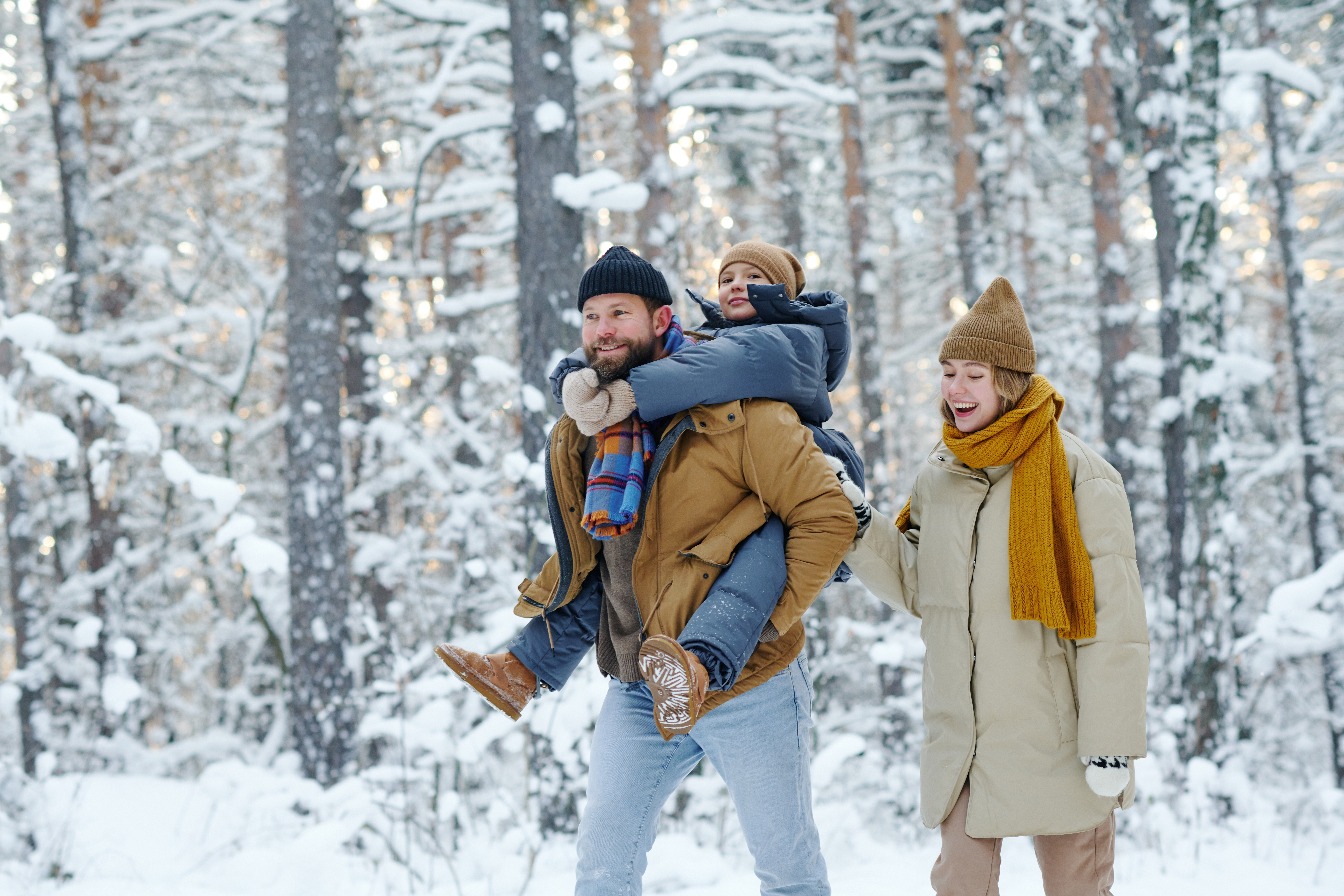 Family walking outside on a snowy trail in winter