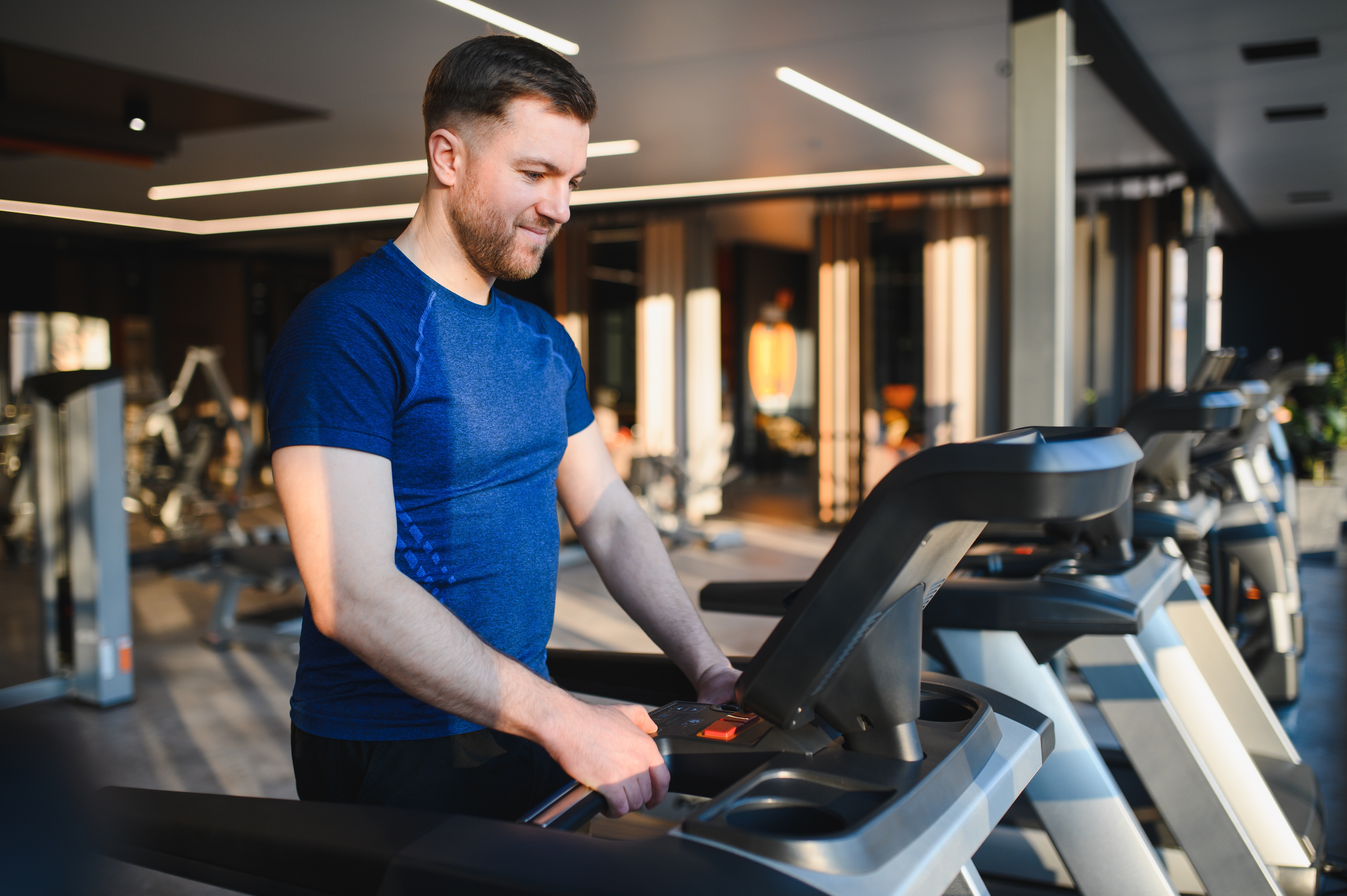 Man preparing to safely run indoors on treadmill