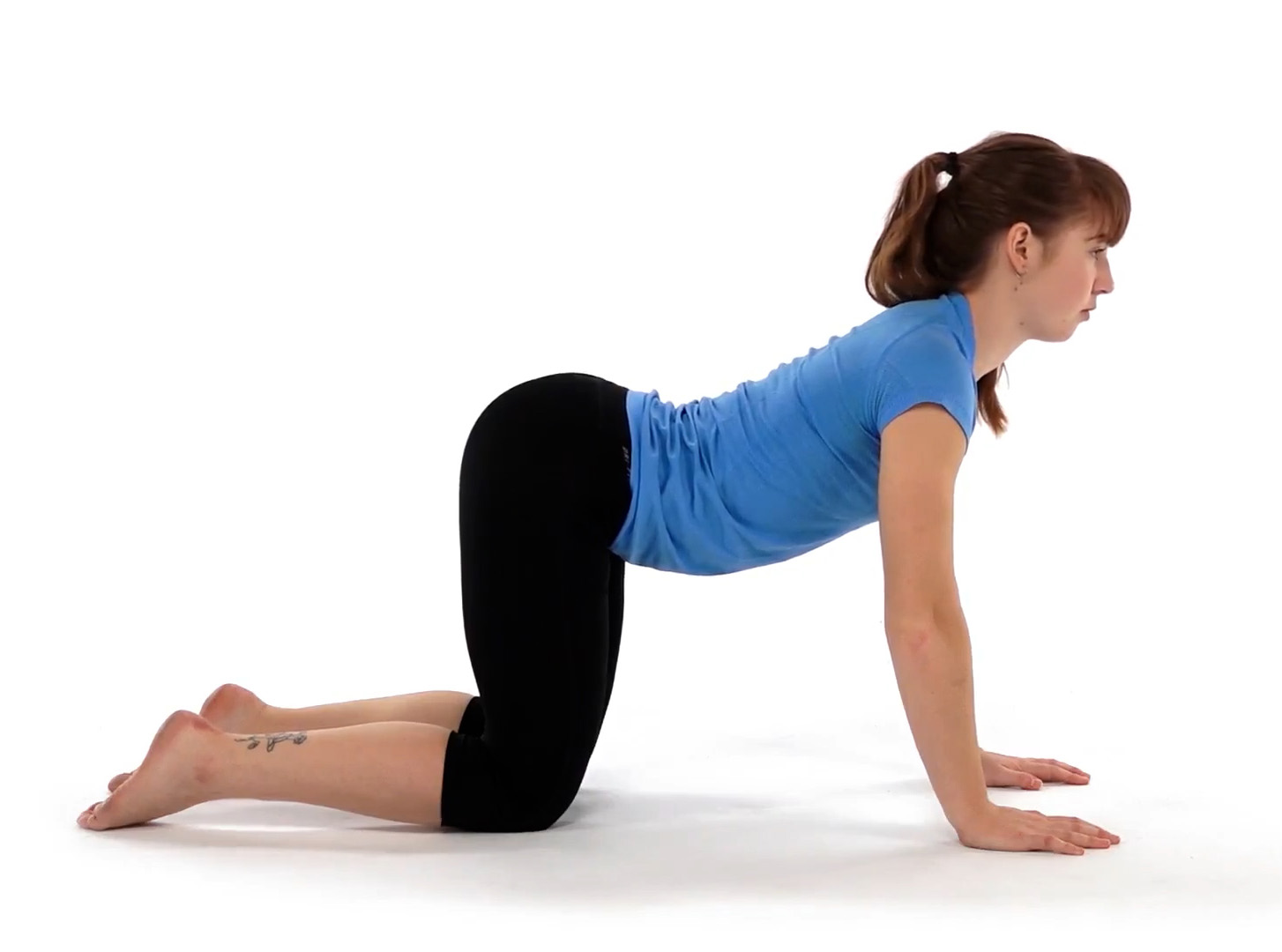 women relieving low back pain with cat-camel stretch