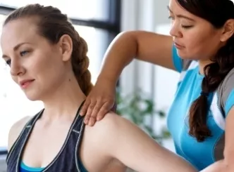 Services woman massaging another womans shoulder